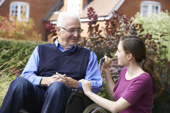46128998 - adult daughter visiting father in wheelchair